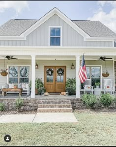 a white house with an american flag on the front porch