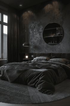 a large bed sitting next to a window in a bedroom under a round light fixture