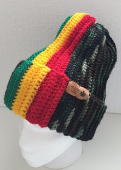 a multicolored knitted beanie hat on a white mannequin head