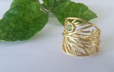 This elegant Leaf Ring is Hand Crafted from Gold Plated Sterling Silver 925, and a Peridot Stone. Inspired by Nature, this Leaf Ring, is suitable for everyday use & any occasion.  This is a great gift for nature lovers! You will receive it in a beautiful package ready for gift giving! *For longer life of jewelry, avoid contact with water ,body lotions , perfumes etc. Nature-inspired Peridot Rings As Gift, Chrysocolla Ring, Silver Leaf Ring, Triangle Ring, Blue Stone Ring, Peridot Stone, Leaf Ring, Gifts For Nature Lovers, Ring Gold