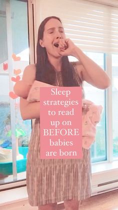 a woman standing in front of a window with her mouth open and holding a sign that says sleep struggles to read up on before babies are born