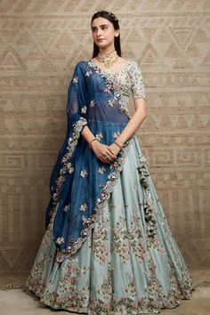 Jade lehenga in silk base with all over floral embroidery. Paired with embroidered blouse and blue dupatta.
Components: 3
Pattern: Embroidered
Type Of Work: Floral
Neckline: Round
Sleeve Type: Half
Fabric: Lehenga and Blouse: Silk, Dupatta: Organza
Color: Green, Blue
Other Details: 
Floral embroidery
Tassel details
Scallop hem dupatta
Occasion: Wedding - Aza Fashions Orang India, Lehenga And Blouse, Simple Lehenga, Half Saree Lehenga, Indian Outfits Lehenga, Wedding Lehenga Designs, Lehenga Designs Simple, Lehnga Dress, Gaun Fashion