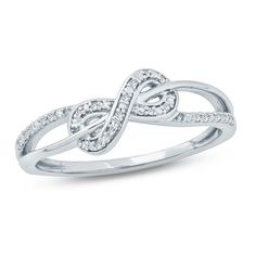 a white gold ring with diamonds in the middle and an intertwined design on top