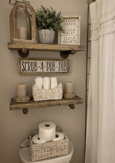 a bathroom with two shelves above the toilet