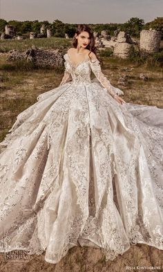 a woman in a wedding dress standing on the ground with her hands behind her back