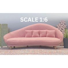 a pink couch sitting on top of a rug next to a potted plant