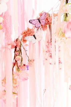 pink flowers and butterflies hanging from the ceiling