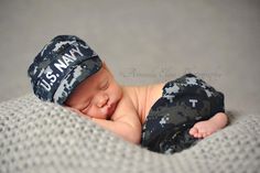 a newborn baby wearing a us navy hat