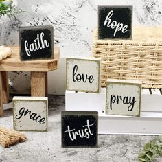 three wooden blocks with the words faith, love, and pray on them sitting next to a wicker basket