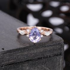 a tan and white diamond ring on top of a wooden table