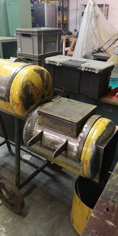 a large metal object sitting on top of a table in a room filled with other items