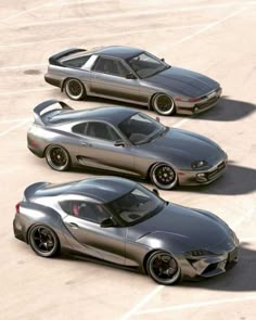 three silver sports cars parked in a parking lot next to each other on top of cement