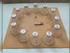 a clock made out of glass bottles on top of a piece of cardboard with numbers in the middle