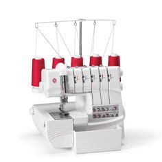 a white sewing machine with red spools on it's head and thread