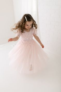 The Perfect Sienna Flower Girl Dress with very soft blush pink lace on the neckline and floor-length tulle skirt adds extra elegance to the dress. Princess Style Lace Dress For Dress-up, Fitted Lace Dress With Lace Sleeves For Dress-up, Princess Dress With Lace Bodice And Tulle For Dress-up, Tulle Dress With Lace Trim For Dress-up, Fitted Princess Dress With Lace Bodice For Dress-up, Fitted Princess Dress With Lace Bodice And Tulle, Wedding Tutu Dress With Lace Bodice, Elegant Spring Princess Dress With Lace Patchwork, Elegant Bridesmaid Tutu Dress With Lace Trim