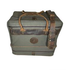 an old suitcase with leather handles and straps on the handle is sitting against a white background