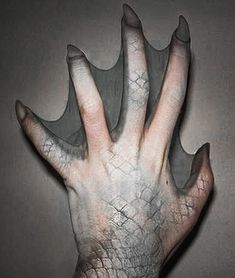 a person's hand is covered in white paint