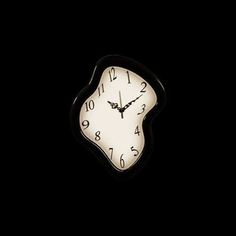 a black and white clock in the dark