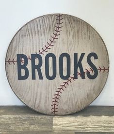 a wooden sign that says brooks with a baseball on it