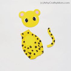 a paper cut out of a cheetah sitting on top of a white surface