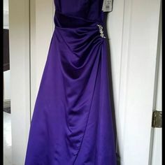 a purple dress hanging on a door