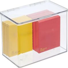 three different colored sticky notes in a clear box