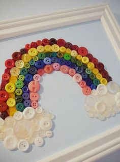 there is a rainbow made out of buttons on the wall with words written in arabic