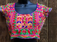 "Colorful embroidered crop top.  Hook eye closure in back. No tags - estimated size small/mediu - please see measurements. In good vintage condition.  Measurements taken across front laid flat. 17\" across front armpit to armpit or 34\" around 13.5\" across front of waist  14\" length top of shoulder to bottom" Embroidered Fitted Bohemian Crop Top, Fitted Embroidered Bohemian Crop Top, Fitted Bohemian Embroidered Crop Top, Multicolor Cotton Crop Top, Multicolor Cotton Cropped Crop Top, Fitted Bohemian Crop Top With Floral Embroidery, Fitted Embroidered Festival Crop Top, Traditional Fitted Crop Top For Festivals, Bohemian Fitted Crop Top With Floral Embroidery