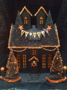 a black and orange christmas house with decorations