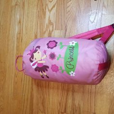 a pink bag sitting on top of a wooden floor