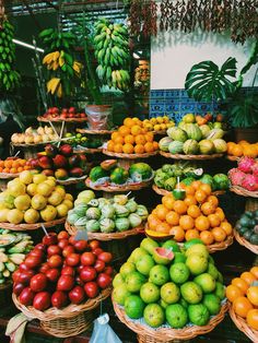 many baskets filled with different types of fruits