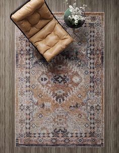 an overhead view of a rug with a chair and potted plant