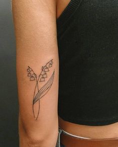 a woman's arm with a flower tattoo on the left side of her arm