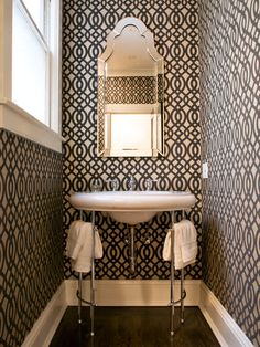 a bathroom with black and white patterned walls