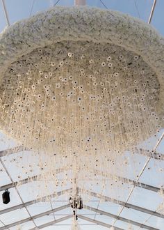 the chandelier is hanging from the ceiling in front of an open air tent