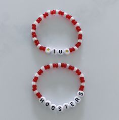 Show your school pride and complete your game day outfit with a custom scarlet red and white beaded bracelet for Indiana University! Personalized Red Casual Jewelry, Customized Red Beaded Bracelets With Round Beads, Customized Red Casual Jewelry, Customized Casual Red Jewelry, Casual Customized Red Jewelry, Casual Red Customized Jewelry, Red Team Spirit Bracelets For Gifts, Personalized Casual Red Jewelry, Casual Personalized Red Jewelry