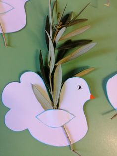 paper cut out of the shape of a duck with leaves on it