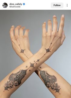 two hands with tattoos on their arms