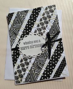 a black and white birthday card with a bow on the front that says, wishing you a happy birthday