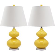 two yellow lamps sitting next to each other on top of a white table lamp shade