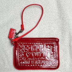 ***Never Used*** Coach Zipper Top Wristlet Is 6" X 4" With 13" Wrist Strap In Red. Gray, Black & Ivory Inside Lining. Has A Cute Little Coach Tag Hanging From The Silver Strap Holder. Plain Red, Silver Design, Coach Wristlet, Zipper Top, Wrist Strap, Coach Bags, Zipper, Red, Silver