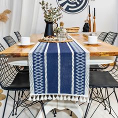 a dining room table covered with a blue and white table runner