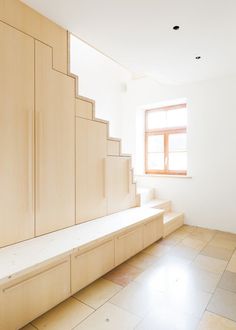 an empty room with some stairs and cabinets