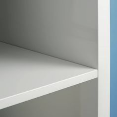 an empty shelf in a blue and white room