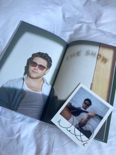 an open book with a photo of a man in sunglasses on the cover and inside