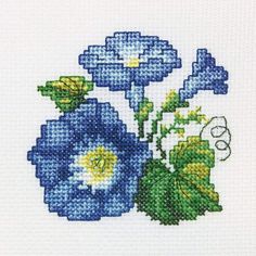 blue flowers with green leaves are shown in this cross stitch pattern