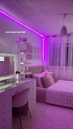 a bedroom with purple lighting and a bed in the corner next to a desk that has a mirror on it