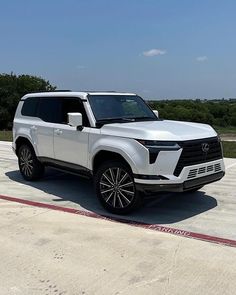 a white suv parked on top of an airport tarmac