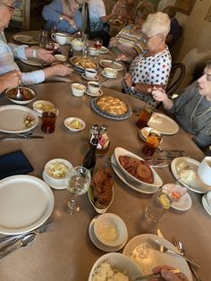 a group of people sitting around a table eating food