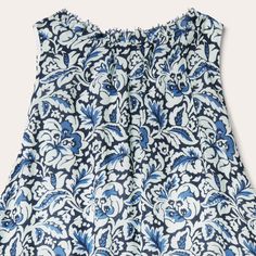 This sleeveless prairie dress is crafted from soft, lightweight 100% rayon, featuring a richly colored allover Indigo Tapestry print. The classic, frontier-inspired style features a ruffled collar with self-covered button closure and keyhole, combined with an elastic waist and ruffled hemline. Fully lined for comfort and ease of movement, it has a relaxed elegance perfect for casual day or evening wear. Ruffled Collar With Self Covered Button Closure And Keyhole Elastic Waist Ruffled Hemline Ful Sleeveless Dress With Smocked Back For Gatherings, Sleeveless Ruffled Dress For Gatherings, Sleeveless Dress With Gathered Neckline In Blue, Sleeveless Sundress For Gatherings, Sleeveless Blue Dress With Gathered Neckline, Summer Sleeveless Peasant Dress, Spring Sleeveless Peasant Dress, Sleeveless Peasant Summer Dress, Peasant Style Sleeveless Summer Dress